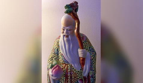 A statue of an old man holding a staff.